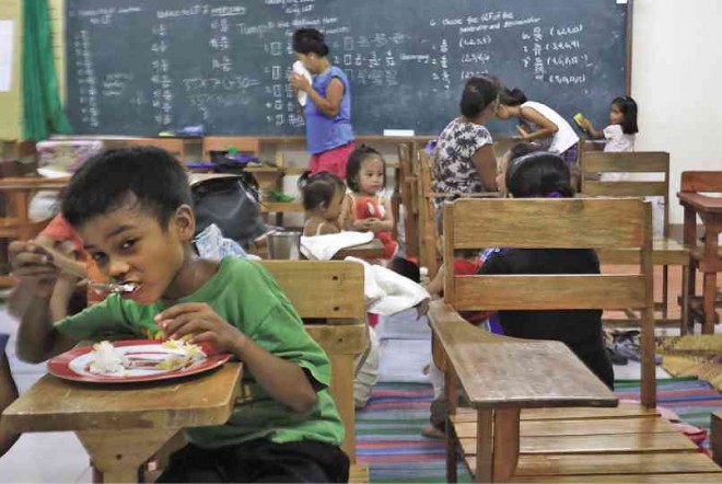RESIDENTS living within the 6-kilometer permanent danger zone of Mayon Volcano seek temporary shelter at Camalig North Central School in Camalig town, Albay province. MARK ALVIC ESPLANA/INQUIRER SOUTHERN LUZON