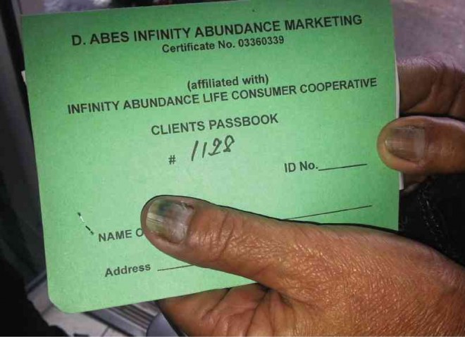 A SUPPOSED passbook of the D. Abes Infinity Abundance Marketing DELFIN T. MALLARI JR./INQUIRER SOUTHERN LUZON 