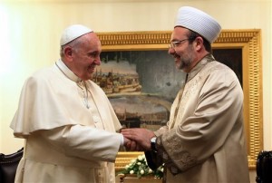 In this photo made available by Turkey's Religious Affairs Office, Pope Francis, left, and head of Turkey's Religious Affairs Mehmet Gormez speak during a meeting in Ankara, Turkey, Friday, Nov. 28, 2014. Under heavy security measures Pope Francis arrived in Turkey for a three-day visit. (AP Photo/Turkey's Religious Affairs)