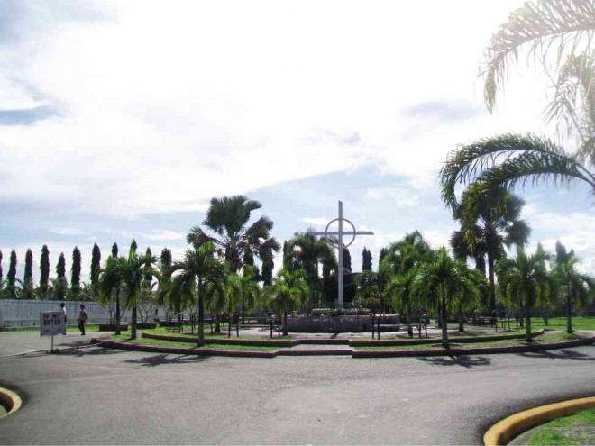 THE WELL-PAVED road leading to a giant cross  at the center of the sprawling La Filipina Public Cemetery in Tagum City, Davao del Norte province,  as seen on Oct. 29. The public burial ground has become a tourist draw due to its “park ambience” and orderly structures.     photo: FRINSTON LIM 