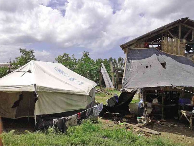 THIS tent in Barangay Bantigue, Bantayan town, served as the home of Teodula Pastrano, who was able to build a shack beside it after a few months. But when it rains, the Pastrano family still seeks refuge in the tent. PETER L. ROMANILLOS/CEBU DAILY NEWS