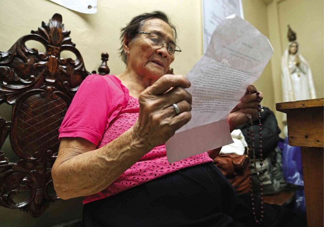 STORMING  heaven with prayers is evacuee Teodora Factor, 82, who recites the “Oratio Imperata” at the bishop’s residence in Borongan City, Eastern Samar province. RAFFY LERMA 
