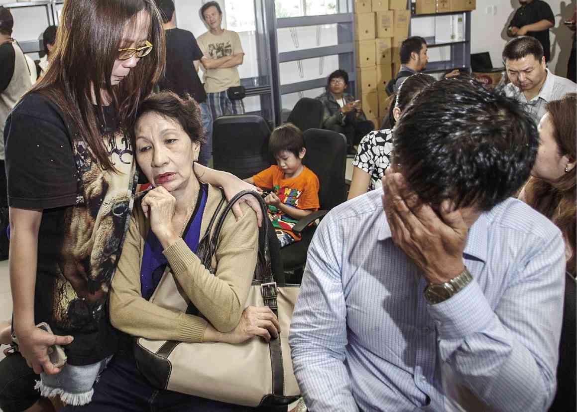 NO WORD  Relatives of passengers of the missing AirAsia Flight QZ8501 wait for news at Juanda International Airport in Surabaya in East Java.  AFP
