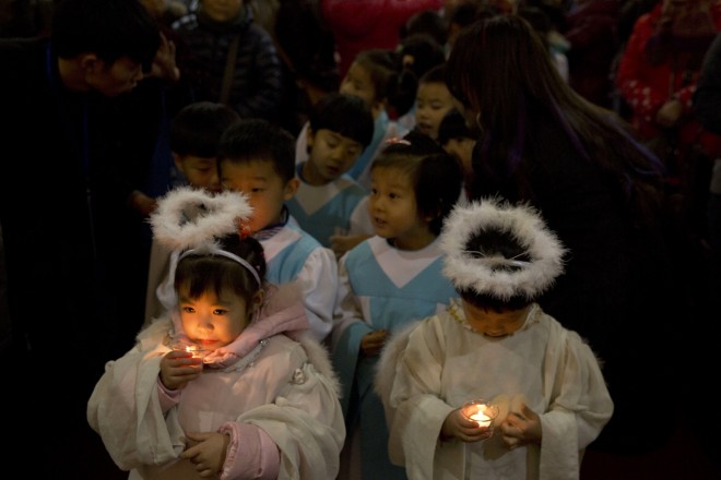 Children dressed as angels take part in a Christmas Eve mass at the South Cathedral official Catholic church in Beijing, China, Wednesday, Dec. 24, 2014. AP