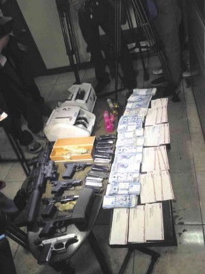 TOOLS OF THE TRADE  NBI agents found money counting machines, a Bushmaster rifle, pistols, cash, checks and other items during the raid on the prisoners’ quarters.  CONTRIBUTED PHOTO