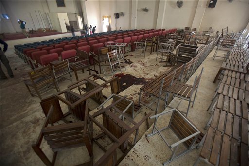 Chairs are upturned and blood stains the floor at the Army Public School auditorium the day after Taliban gunmen stormed the school in Peshawar, Pakistan, Wednesday, Dec. 17, 2014.  AP