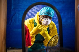  In this Oct. 16, 2014, file photo, a healthcare worker dons protective gear before entering an Ebola treatment center in Freetown, Sierra Leone. AP