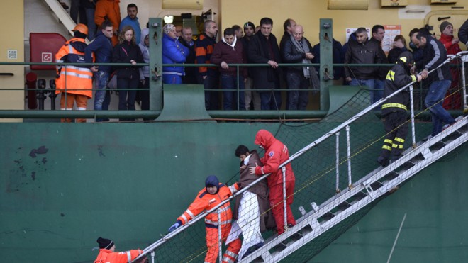 Passengers and crew of the Italian-flagged Norman Atlantic, that caught fire in the Adriatic Sea, disembark from a ship in Bari harbor, southern Italy, Monday, Dec. 29, 2014. A ferry carrying nearly 500 people caught fire off the Greek island of Corfu early Sunday, trapping passengers on the top decks as gale-force winds and choppy seas hampered the evacuation. Greek and Italian rescue helicopters and vessels struggled to reach the stricken ferry, with nearby merchant ships lining up to form a wall against the raging gusts. (AP Photo/Luigi Mistrulli)