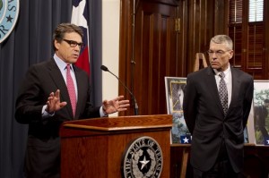Texas Gov. Rick Perry, left, is joined by Texas Department of Public Safety Director Steve McGraw, during a news conference on Wednesday, Dec. 3, 2014 at the Capitol in Austin. AP
