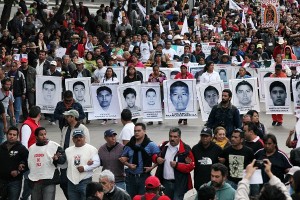 Relatives of the 43 missing students from the Isidro Burgos rural teachers college march holding pictures of their missing loved ones during a protest in Mexico City,  Friday, Dec. 26, 2014. Protesters marched through the city to mark the three months since the 43 students were taken by municipal police and then handed over to a drug gang to be killed and then the bodies burned, according to the results of the Attorney General's investigation. AP