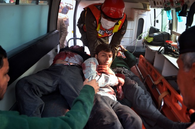 Pakistani rescue workers take out students from an ambulance who injured in the shootout at a school under attack by Taliban gunmen, upon arrival at a local hospital in Peshawar, Pakistan, Tuesday, Dec. 16, 2014. Taliban gunmen stormed a military school in the northwestern Pakistani city, killing and wounding dozens, officials said, in the latest militant violence to hit the already troubled region. AP