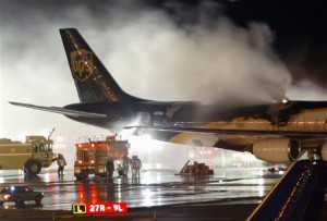 In this Feb. 8, 2006 file photo, firefighters battle a blaze onboard a UPS cargo plane at Philadelphia International Airport in Philadelphia.  AP