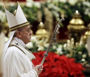 Pope Francis leaves after celebrating the Christmas Eve Mass in St. Peter's Basilica at the Vatican, Wednesday, Dec. 24, 2014. AP