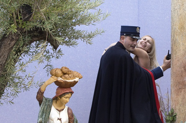 A gendarme from the Vatican's security forces stops a Ukrainian feminist group Femen activist after she snatched the statue of Baby Jesus from the Nativity scene set in St. Peter's Square at the Vatican, Thursday, Dec. 25, 2014. AP