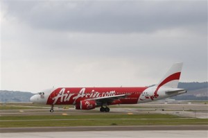 In this Nov. 26, 2014 photo, AirAsia Airbus A320-200 passenger jets are taxing on the tarmac at low cost terminal KLIA2 in Sepang, Malaysia. An AirAsia plane with 162 people on board lost contact with ground control on Sunday, Dec. 28, 2014, while flying over the Java Sea after taking off from a provincial city in Indonesia for Singapore, and search and rescue operations were underway. The plane in this photo is not the plane that went missing while flying from Indonesia to Singapore but one of the same models. (AP Photo/Vincent Thian)