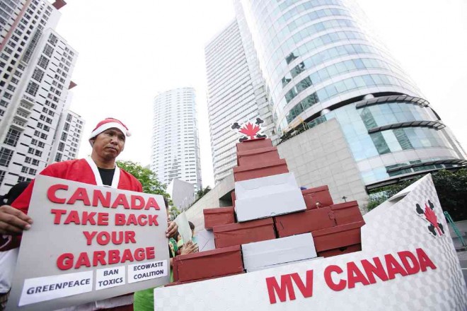  A PROTESTER dressed as Santa Claus urges Canada to ship back to its shores the 50 container vans filled with hazardous waste that remain in the ports of Manila and Subic. NIÑO JESUS ORBETA