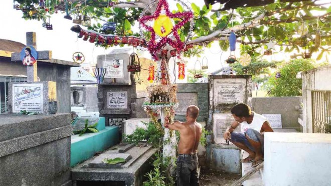 Christmas lights and decor brighten  a public cemetery in Barangay Tanza-Timawa Zone II in Iloilo City,  drawing  visitors and the curious. Nestor P. Burgos Jr. 