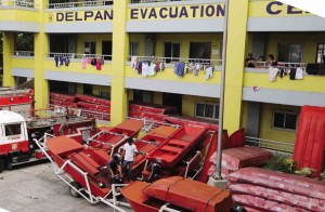 RESCUE boats are prepared Saturday at the Del Pan evacuation center in Tondo, Manila, one of temporary shelters alloted by the city government. photos by JOAN BONDOC 