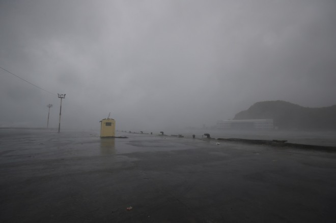 Strong winds and rain from Typhoon Hagupit pound an empty port in Legazpi, Albay province, eastern Philippines on Sunday, Dec. 7, 2014. Typhoon Hagupit slammed into the central Philippines' east coast late Saturday, knocking out power and toppling trees in a region where 650,000 people have fled to safety, still haunted by the massive death and destruction wrought by a monster storm last year. AP/Aaron Favila