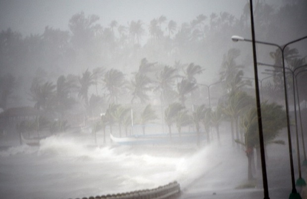 Strong winds and rain pound the seawall hours before Typhoon Hagupit passes near the city of Legazpi on December 7, 2014.  Typhoon Hagupit tore apart homes and sent waves crashing through coastal communities across the eastern Philippines, creating more misery for millions following a barrage of deadly disasters.      AFP PHOTO/TED ALJIBE