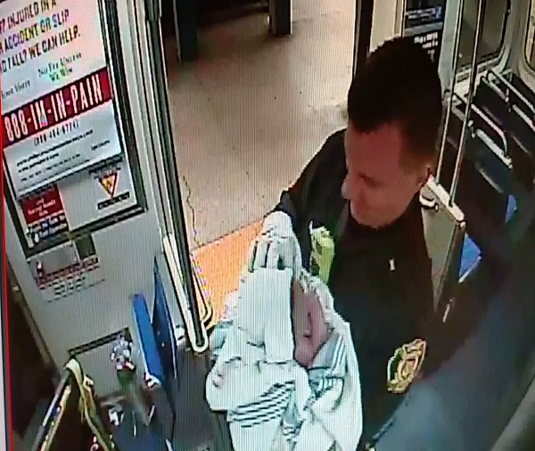 In this image from Thursday, Dec. 25, 2014 surveillance video provided by the Southeastern Pennsylvania Transportation Authority (SEPTA), Philadelphia transit police Sgt. Daniel Caban holds a baby boy he helped deliver aboard a subway train at the 15th and Market streets station in Philadelphia. The mother and newborn were taken to Hahnemann University Hospital, where they were reported in good condition. (AP Photo/SEPTA)