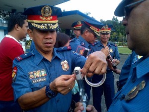 PNP seals firearms muzzle of its policemen to prevent indiscriminate firing during the holiday revelries. NESTOR CORRALES/INQUIRER.net