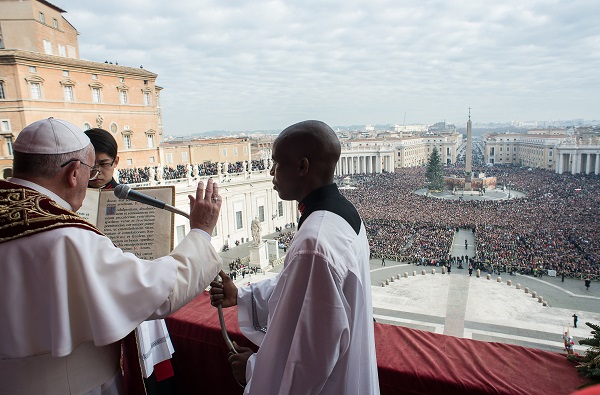 In this picture provided by the Vatican newspaper L'Osservatore Romano, Pope Francis delivers his "Urbi et Orbi" (to the city and to the world) blessing from the central balcony of St. Peter's Basilica at the Vatican, Thursday, Dec. 25, 2014. Tens of thousands of Romans and tourists in St. Peter's Square listened as the pontiff delivered the Catholic church's traditional "Urbi et Orbi" (Latin for "to the city and to the world) Christmas message from the central balcony of St. Peter's Basilica. Francis said: "truly there are so many tears this Christmas." Pope Francis focused his concern Thursday on those weeping in the world this Christmas, singling out refugees, hostages and others suffering in the Middle East, Africa and Ukraine as he prayed for hope and peace. AP Photo/L'Osservatore Romano