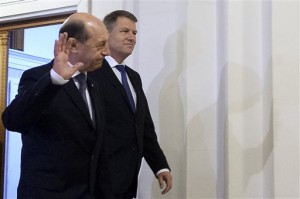 Romanian President in office, Traian Basescu, left, waves to media representatives while arriving alongisde Romania's President-elect, Klaus Iohannis, at Romania's Constitutional Court, in Bucharest, Romania, Friday, Nov. 21, 2014. AP