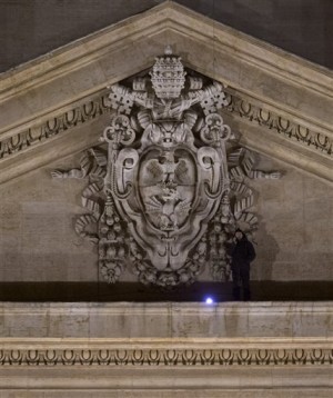 Italian entrepreneur Marcello di Finizio talks on the phone as he stands on the facade of St. Peter’s Cathedral at the Vatican, Sunday, Dec. 21, 2014. Marcello di Finizio lowered himself Sunday onto a narrow ledge on the facade of St. Peter’s Cathedral, the fifth time he has evaded Vatican security to mount a public protest against government reforms from one of Roman Catholicism’s holiest sites. Marcello di Finizio told the Associated Press by telephone from his perch overlooking St. Peter’s Square that he chose the spot above the cathedral’s main entrance because it was more visible than the cupola, which he had scaled on four previous protests. (AP Photo/Alessandra Tarantino)