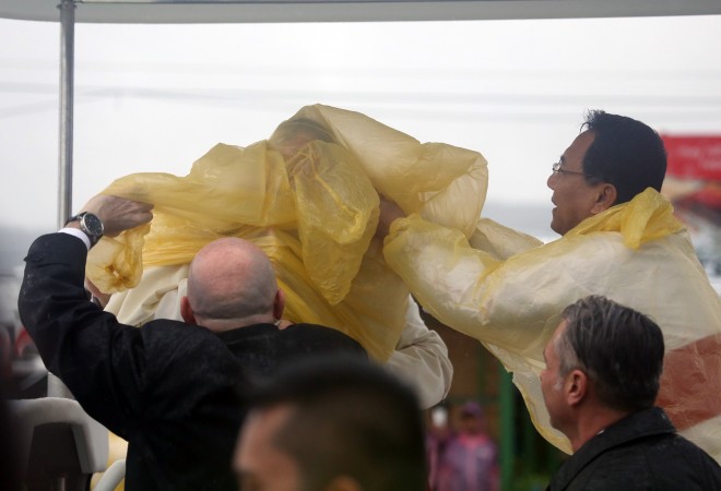 Pope Francis wears a raincoat as Tropical Storm Amang brought rain during his visit in Tacloban. CDN