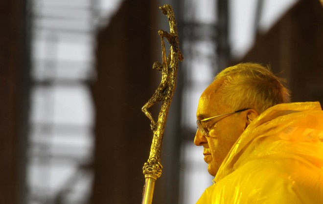 Pope Francis, wearing a yellow raincoat, celebrates mass amidst heavy rains and strong winds near the Tacloban Airport Saturday, January 17, 2015. After the mass, the Pope will visit Palo, Leyte to meet with families of typhoon Yolanda victims. The Pope visit to Leyte was shortened due to on going typhoon in the area. (Photo by Benhur Arcayan/Malacanang Photo Bureau)