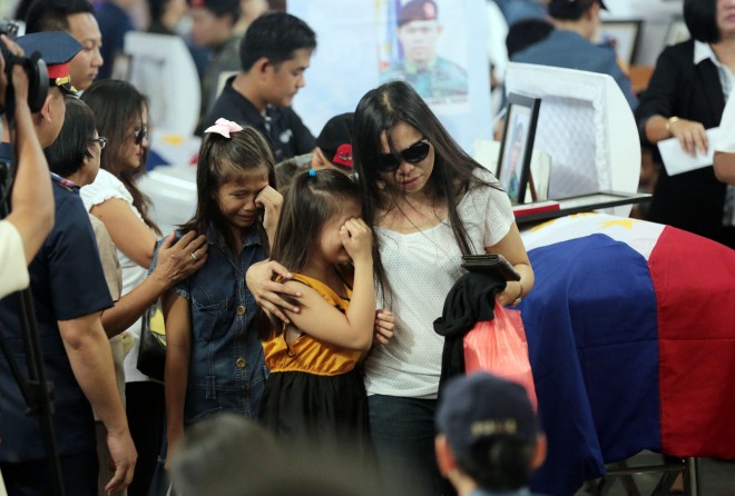 A  family of one of the Special Action Forces (SAF) troopers who perished in the Mamasapano, Maguindanao incident expresses grief during the necrological services at Camp Bagong Diwa in Taguig City on Friday. GRIG C. MONTEGRANDE/INQUIRER