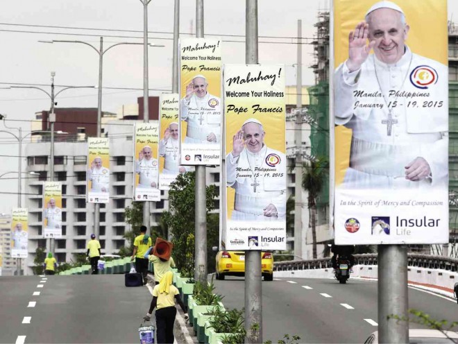  COUNTDOWN  Twelve days to go before the arrival of Pope Francis. Workers spruce up a street in Manila with posters welcoming Pope Francis who visits this predominantly Catholic country for the first time from Jan. 17 to 19.  The Pope will share a meal with survivors of Supertyphoon “Yolanda” (international name: Haiyan) and the Bohol quake, and will celebrate Mass for the public at Rizal Park on Jan. 18. BULLIT MARQUEZ/AP 
