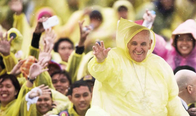  BEFORE TEARS OF JOY  Armed with his trademark charisma, a raincoat-clad Pope Francis dispenses endless hope and joy while he waves to warmly welcoming well-wishers in Tacloban, where his long-awaited visit on Saturday, however, had to be cut short because of heavy rains from Tropical Storm “Amang.”  AFP 