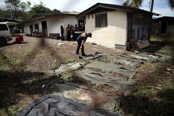 Police crime investigators are seen outside a morgue Tuesday, January 27, 2015, in 6th Division camp as they conduct autopsy to bodies of policemen killed in intense fighting with Moro rebels coddling a Malaysian terror bomb expert in Mamasapano, Maguindanao. JEOFFREY MAITEM / INQUIRER MINDANAO FILE PHOTO