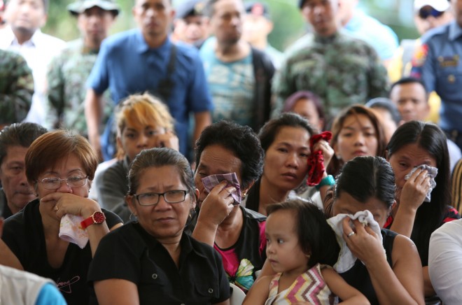 Relatives, symphatizers mourn during the necrological rites for the 44 SAF  victims of the Mamasapano massacre. JOAN BONDOC/INQUIRER