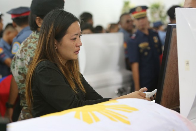 The wife of a SAF trooper cries during the necrological rites for the 44 SAF  victims of the Mamasapano massacre. JOAN BONDOC/INQUIRER