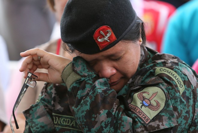 SAF members and other PNP personnel mourn during the necrological service for their 44 comrades killed in Mamasapano town in Maguindanao. JOAN BONDOC/INQUIRER