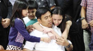 MAYOR AS FATHER FIGURE    The four children of Makati City Mayor Junjun Binay, a widower, throw a protective embrace around him after he’s forcibly brought by Senate security personnel to the session hall. MARIANNE BERMUDEZ