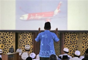 An Indonesian Muslim man prays during a special prayer for the victims of AirAsia Flight 8501 at Al Akbar Mosque in Surabaya, East Java, Indonesia, Friday, Jan. 2, 2015. AP