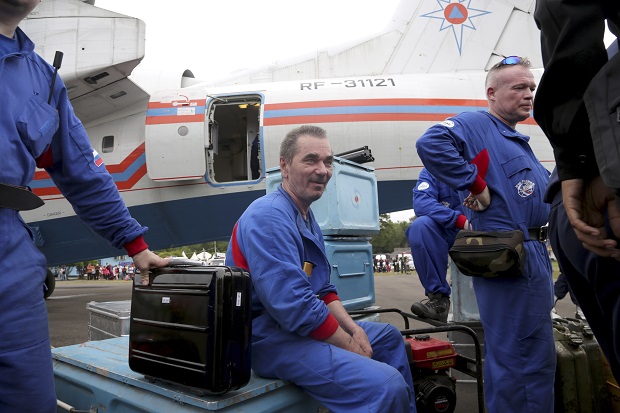 Russian rescuers unload gears from their Beriev Be-200 amphibious aircraft upon arrival to reinforce a search operation for the victims and the wreckage of AirAsia Flight 8501 at Pangkalan Bun Airport, Indonesia, Saturday, Jan. 3, 2015. Indonesian officials were hopeful Saturday they were honing in on the wreckage of the ill-fated plane after sonar equipment detected two large objects on the ocean floor, a full week after the plane went down in stormy weather. AP