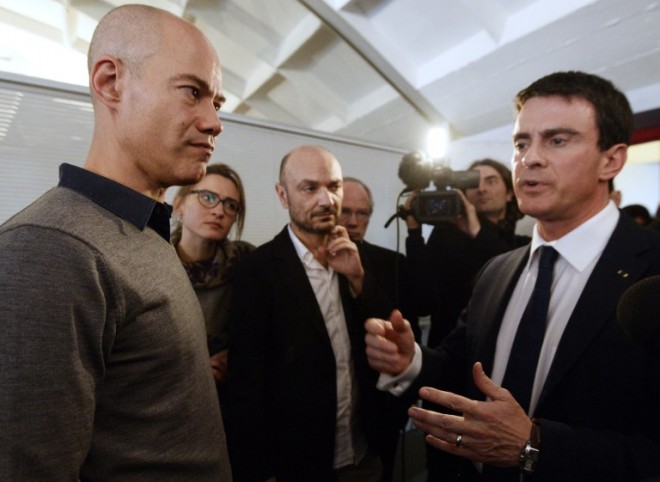  Journalist Laurent Leger (left) listens to Paris Prime Minister Manuel Valls. AFP 