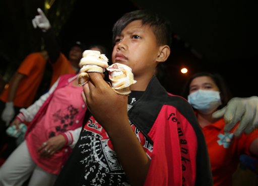 A Filipino boy injured from firecrackers arrives at the East Avenue Medical Center in Quezon City on Thursday, Jan. 1, 2015. (File photo by AARON FAVILA / AP)