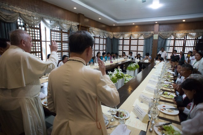 Pope Francis, left, has lunch with survivors of Super Typhoon Yolanda (Haiyan), the November 2013 storm that leveled entire villages and left more than 7,300 people dead or missing, at the Palo Archbishop's residence, Philippines, Saturday, Jan. 17, 2015. Francis traveled to the far eastern Philippines to comfort survivors of devastating Typhoon Haiyan in 2013 on Saturday, but cut his own trip short because of another approaching storm.  AP
