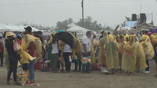 Pilgrims wearing rain coats have started to arrive at the Daniel Romualdez Airport for Pope Francis' mass tomorrow. Photos by Marc Jayson Cayabyab/INQUIRER.net