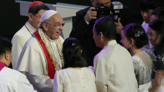 Pope Francis reacts while meeting a hearing-impaired father and his family at the Mall of Asia arena in Manila, Philippines, Friday, Jan. 16, 2015. Pope Francis is on a five-day apostolic visit in this predominantly Catholic nation in Asia. (AP Photo/Wally Santana)