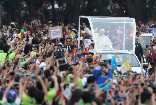 JANUARY 18, 2015 Pope Francis waves to the crowd upon his arrival at the  University of Santo Tomas (UST)  to give his traditional address to the youth at the UST football field. PHOTO BY EDWIN BACASMAS