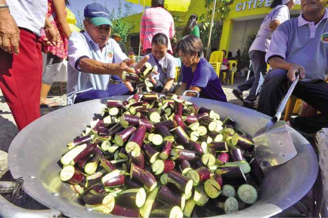 Residents of Villasis town in Pangasinan province prepare “pinakbet,” a native vegetable dish, with locally grown “talong” (eggplants) among the major ingredients, during the Talong Festival. WILLIE LOMIBAO/CONTRIBUTOR 