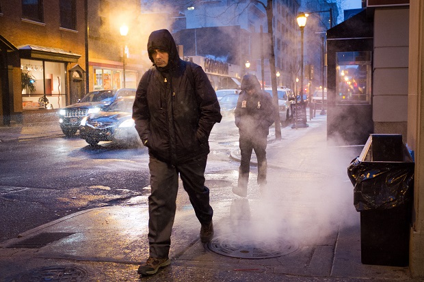 Early morning commuters make their way through rising steam along S. 16th St. near Sansom in Philadelphia on Tuesday, Jan. 6, 2015. The forecast is for light snow and dropping temperatures. (AP Photo/The Philadelphia Inquirer, Alejandro A. Alvarez)