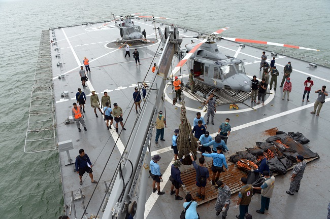 Indonesian's Navy personnel prepare the dead bodies of the passengers of AirAsia Flight 8501, on Indonesian navy vessel KRI Banda Aceh, to transfer them by helicopters at sea off the coast of Pangkalan Bun, Indonesia, Saturday, Jan. 3, 2015.  AP